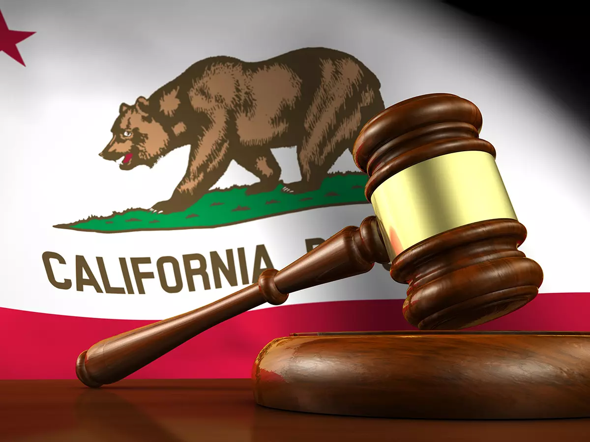 California state flag with justice gavel in front of it